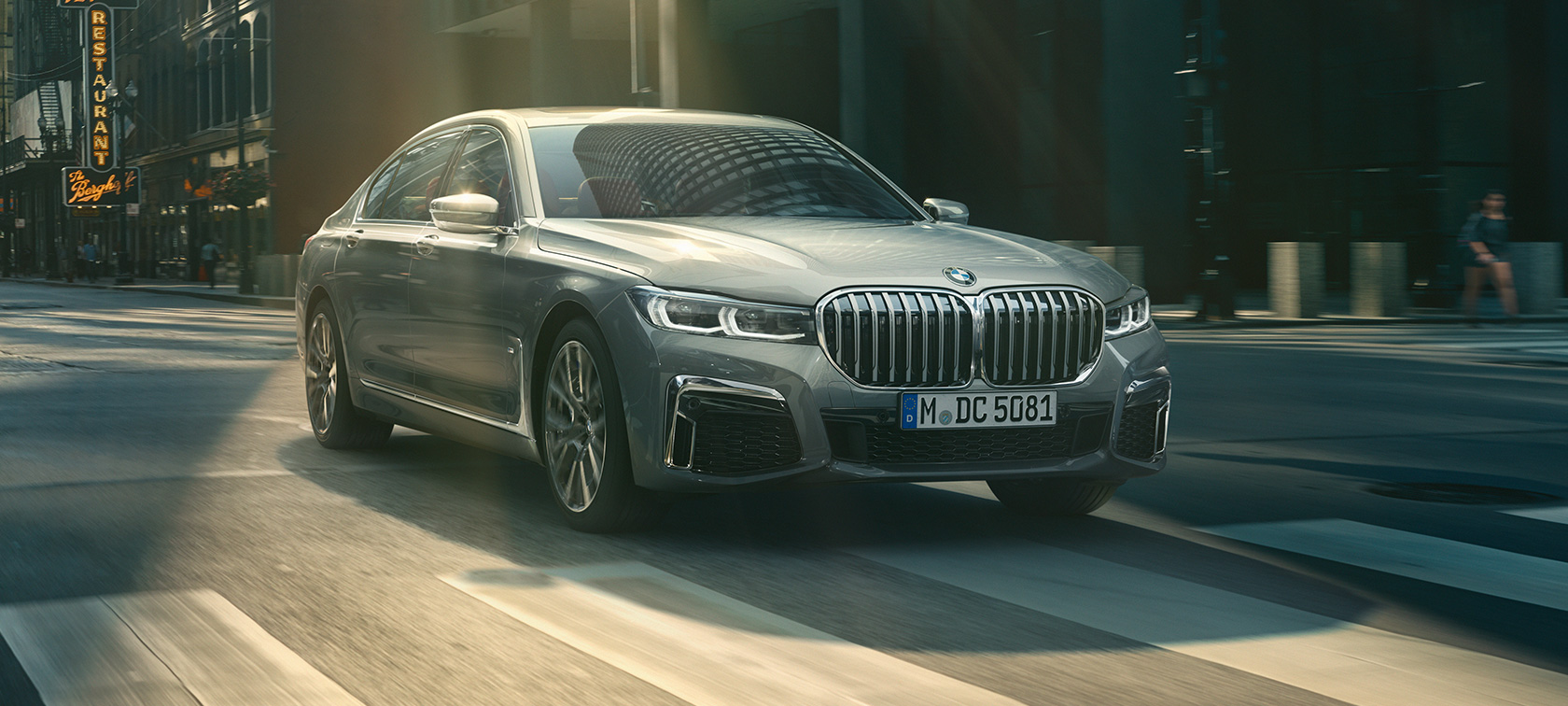 BMW Serie 7 gris, en una vista de tres cuartos del frontal, que circula por un entorno urbano